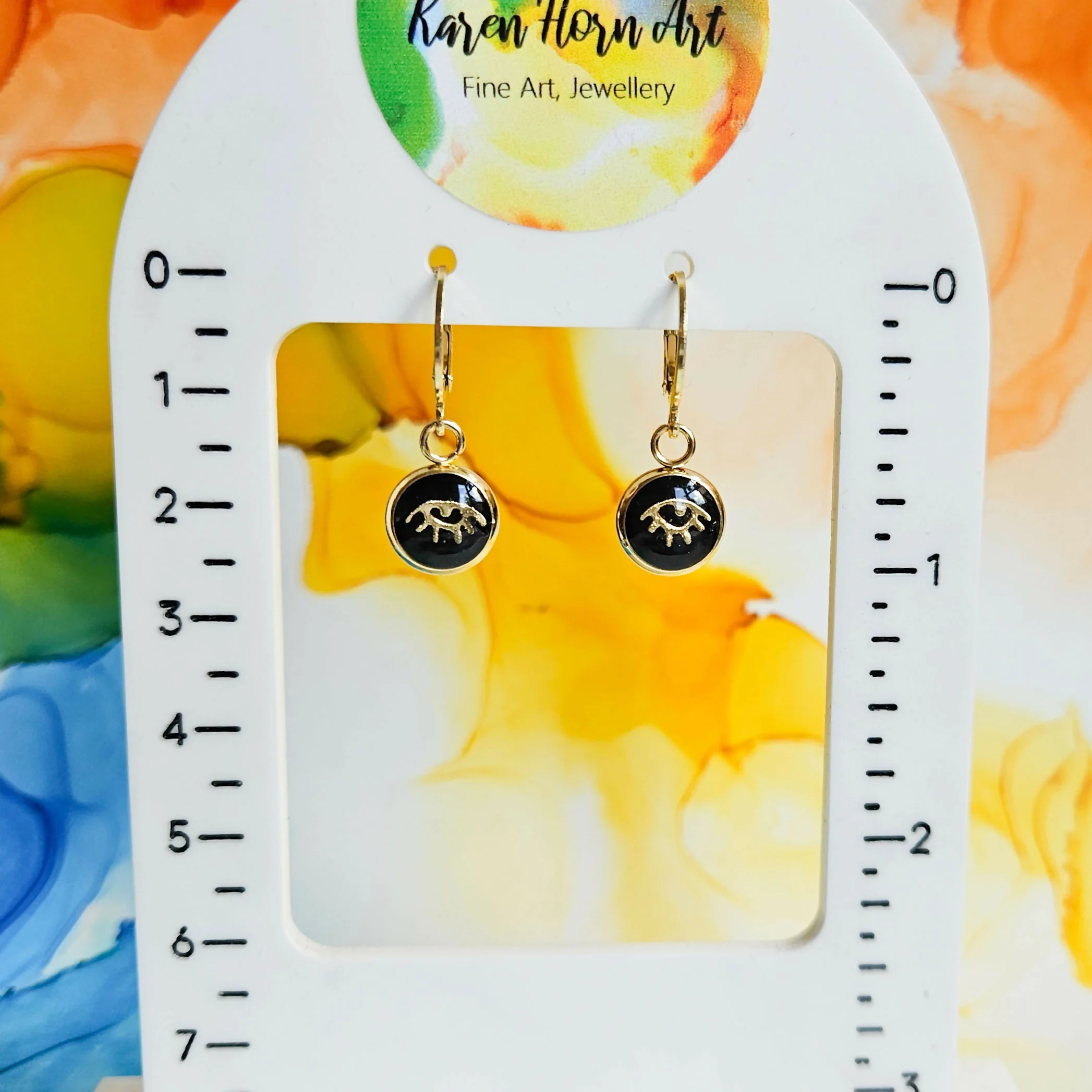 Handmade Black And Gold Evil Eye Resin Charms On Huggie Hoops - Image 2
