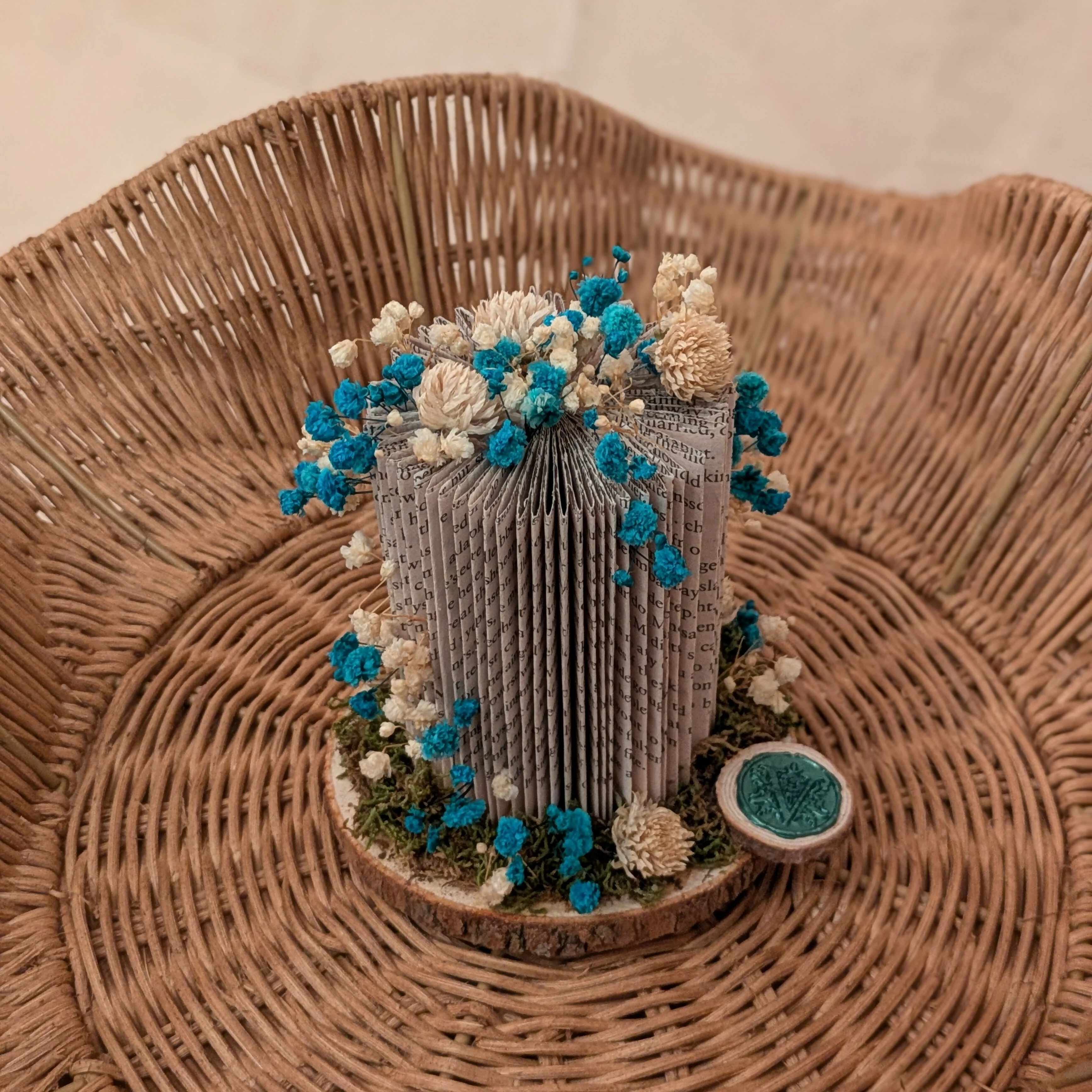 Miniature Blue Floral Arrangement on Wooden Slice.