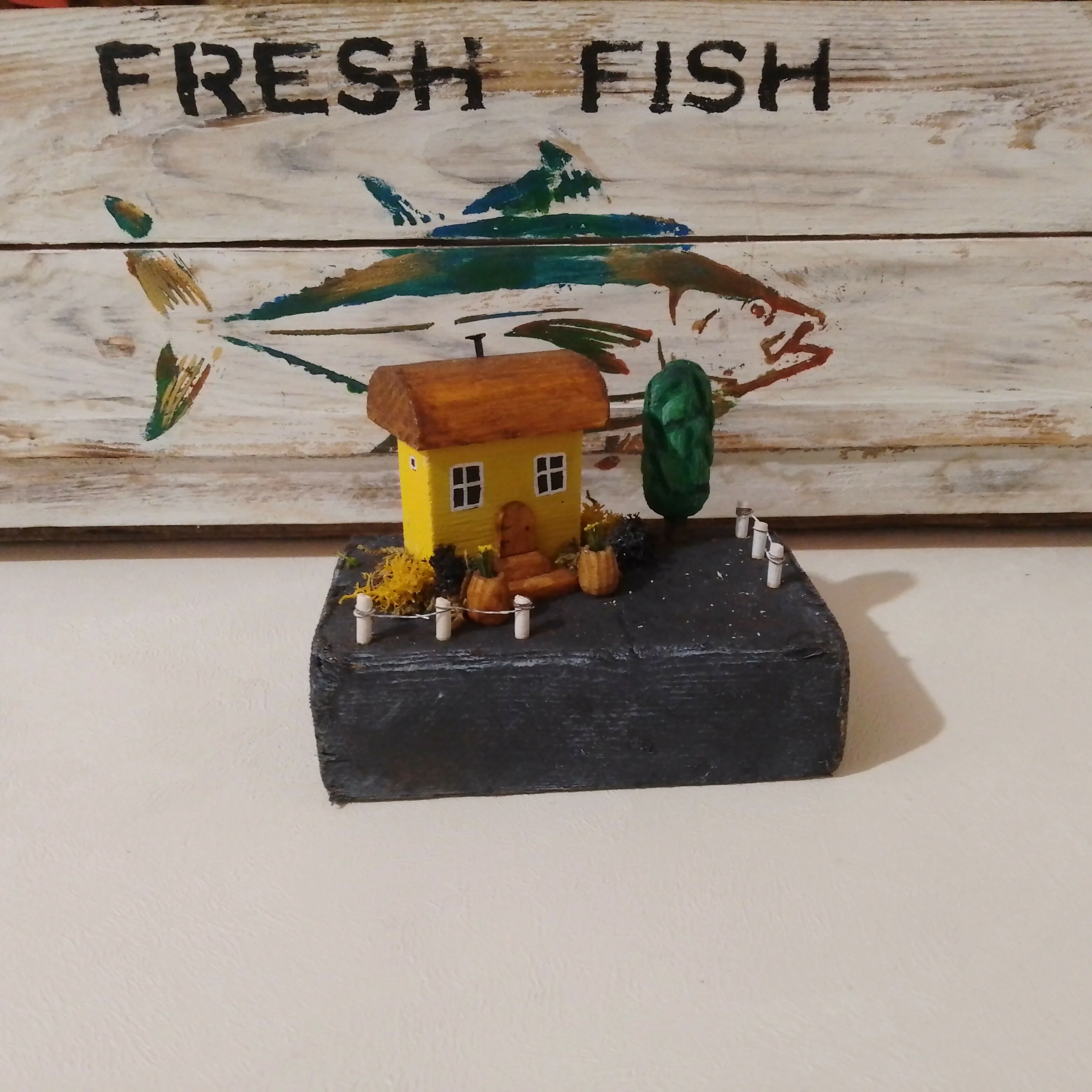 Small Yellow House with Plants, on Driftwood