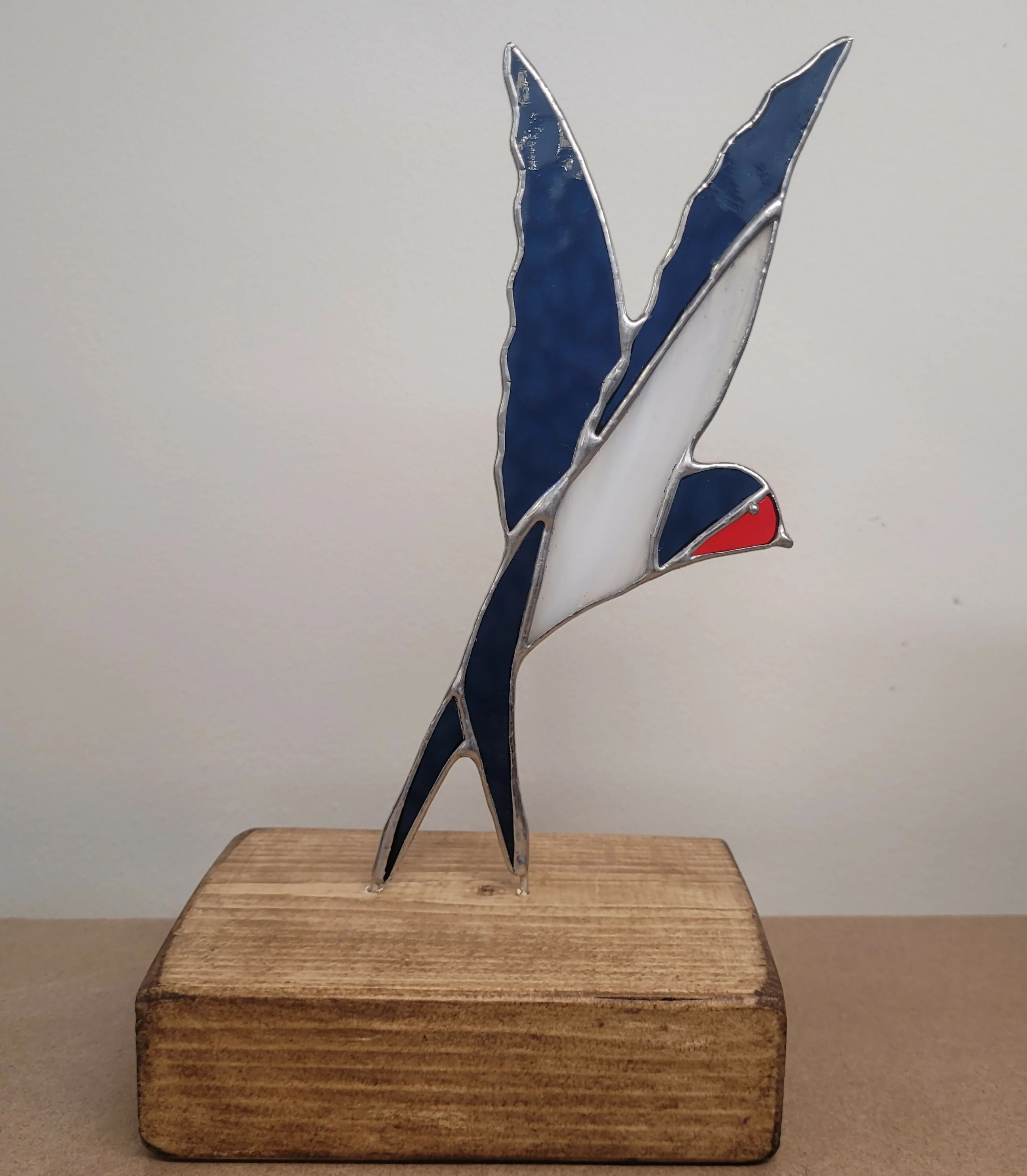 Glass Swallow on Wood