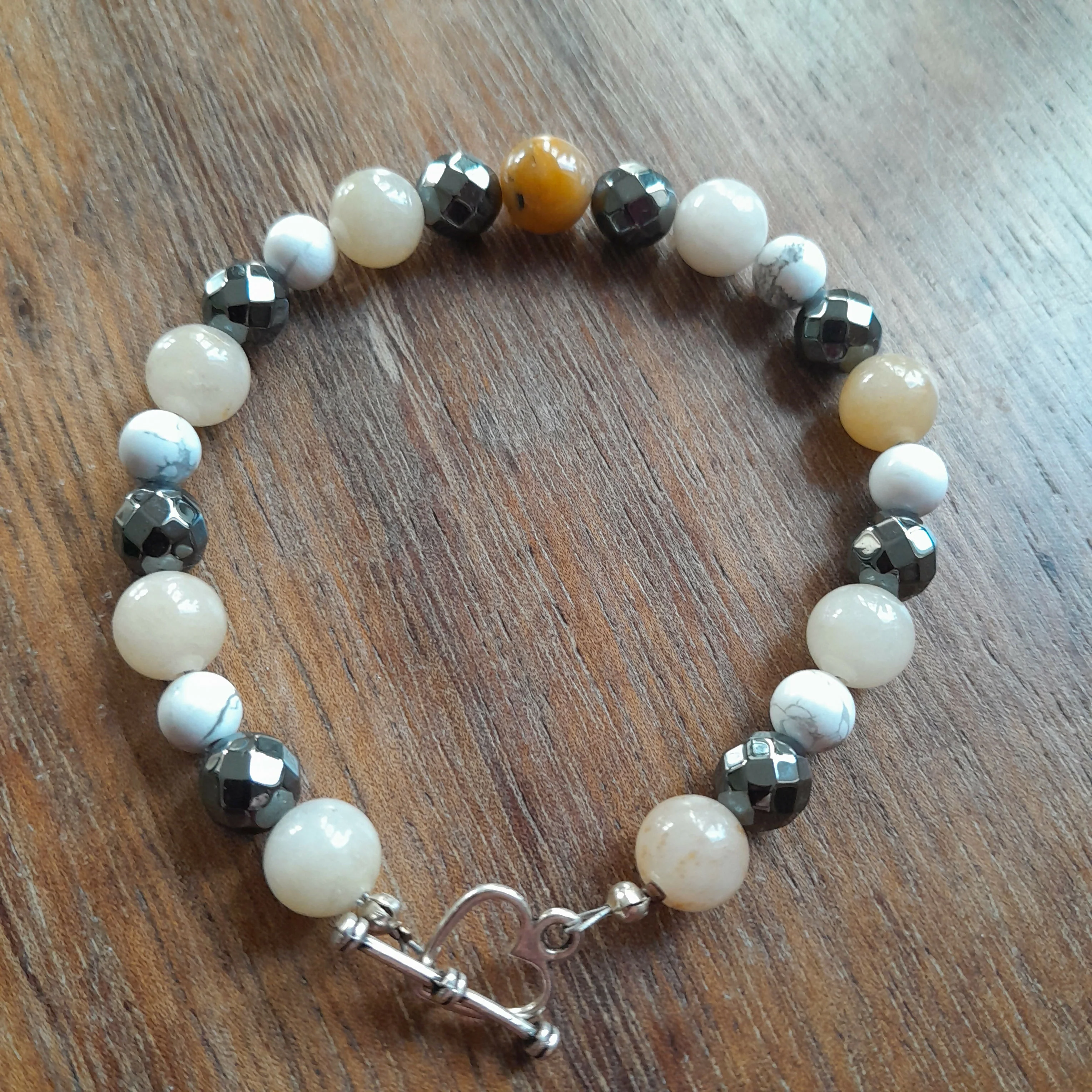 Tibetan Silver Toggle Catch Bracelet with Aged Yellow Jade, Faceted Grey Hematite and Veined Howlite.