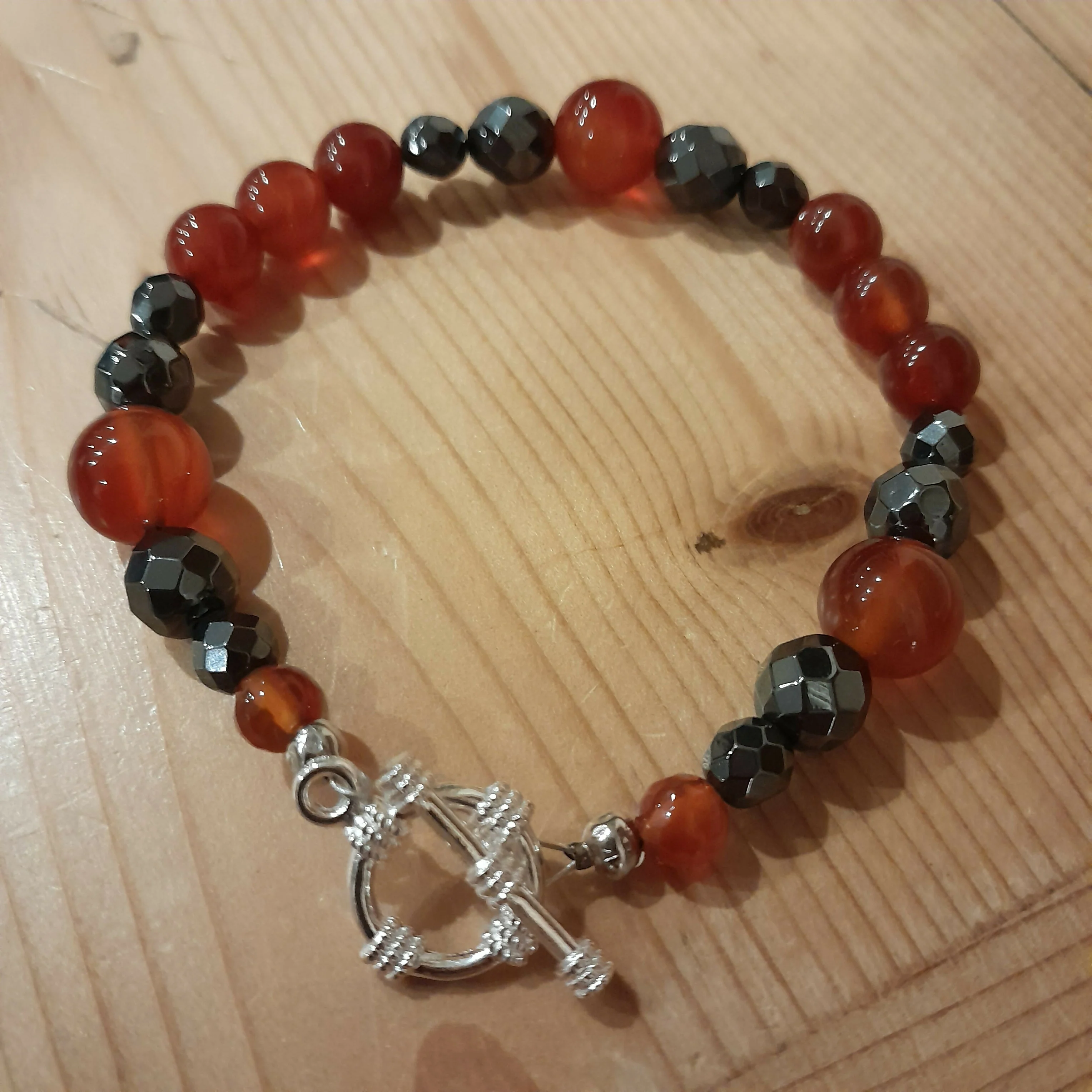 Tibetan Silver Toggle Catch Bracelet with Carnelian and Faceted Grey Hematite.