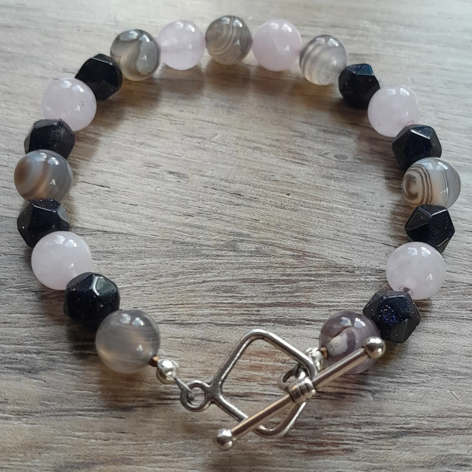 Tibetan Silver Toggle Catch Bracelet with Grey Banded Agate, Faceted Navy Goldstone and Rose Quartz.