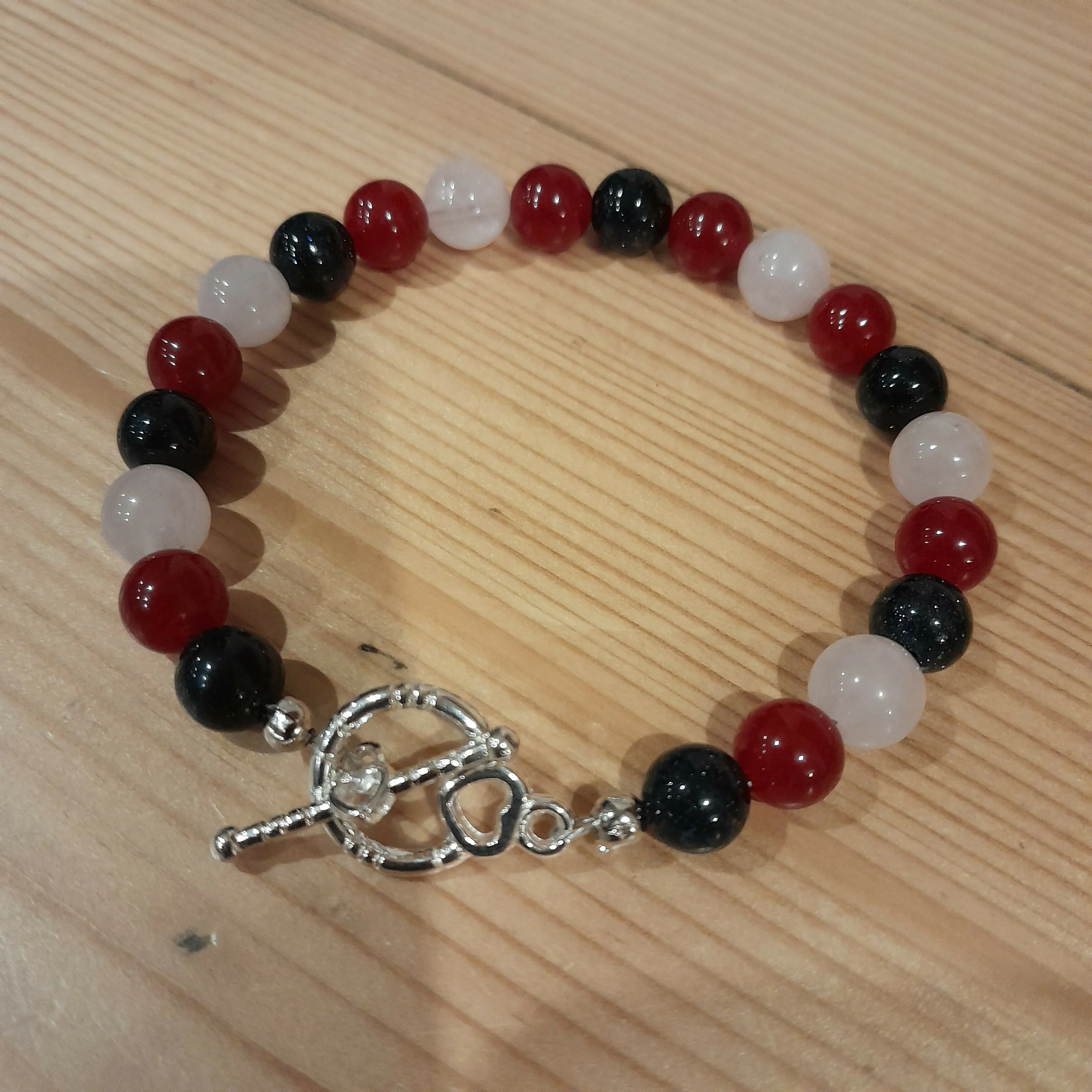 Tibetan Silver Toggle Catch Bracelet with Navy Goldstone, Red Chalcedony and Rose Quartz.