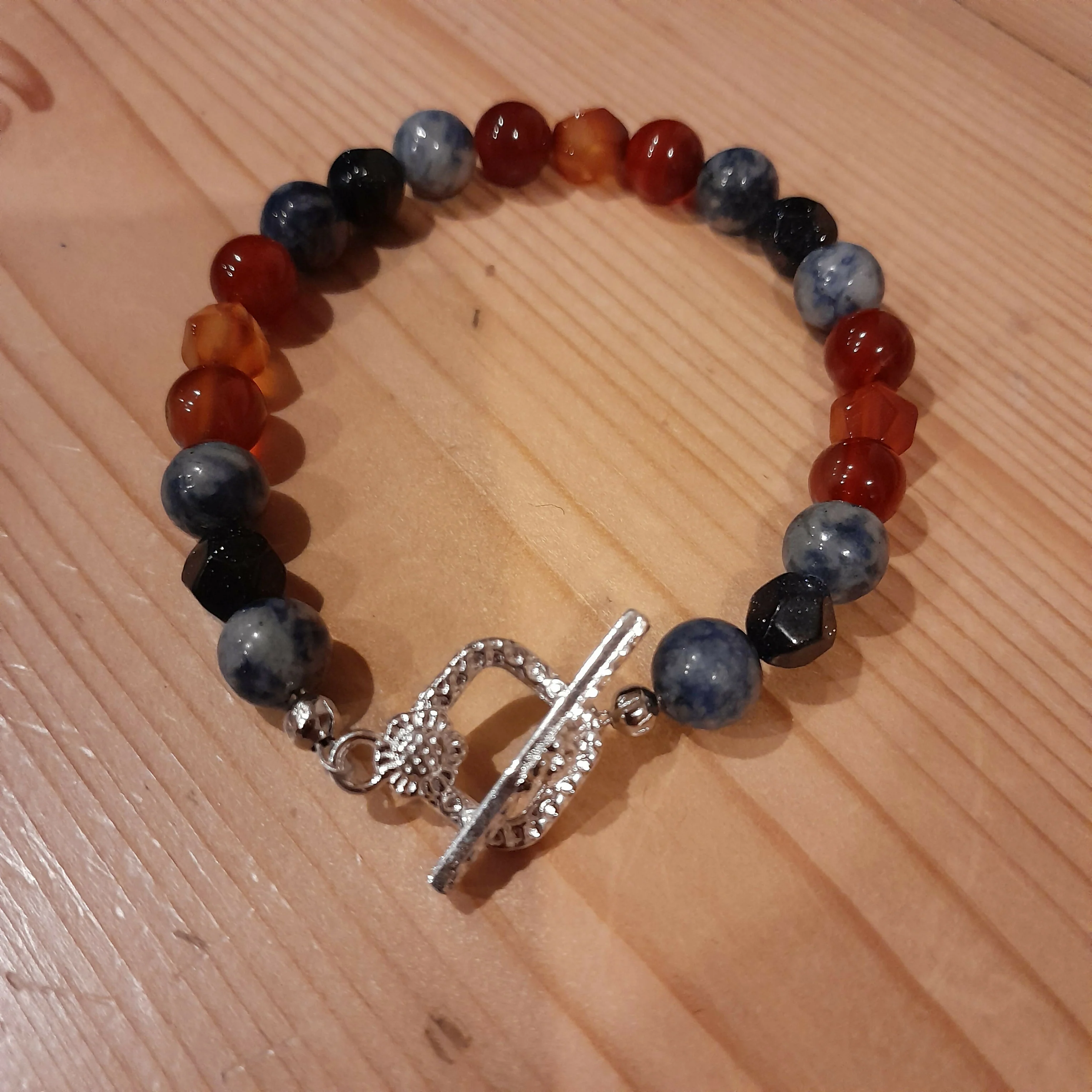 Tibetan Silver Toggle Catch Bracelet with Spotted Blue Jasper, Faceted Navy Goldstone and Carnelian.